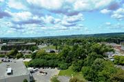 Hamilton apartment for rent - A parking lot is in the foreground of a town.