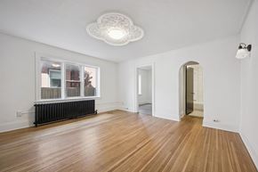 Kitchener apartment for rent - A room with wooden floors and white walls.