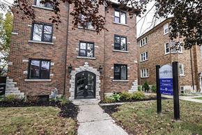 Kitchener apartment for rent - A brick building with a sign that says "BROOKVILLE" in front of it.