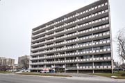 Hamilton apartment for rent - A large grey building with many windows and balconies.