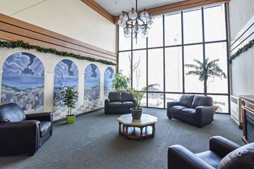 Hamilton apartment for rent - A living room with a large window and a painting on the wall.