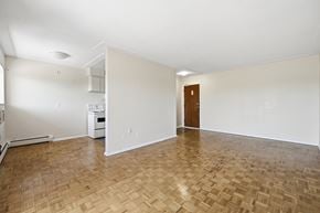 Hamilton apartment for rent - A room with a wooden floor and a door on the right side.