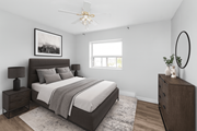 Stoney Creek apartment for rent - A bedroom with a large bed, a nightstand, and a dresser.