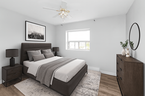 Stoney Creek apartment for rent - A bedroom with a large bed, a nightstand, and a dresser.
