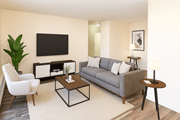 Hamilton apartment for rent - A living room with a grey couch, a white chair, a black coffee table, and a flat screen TV mounted on the wall.