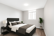 Stoney Creek apartment for rent - A bedroom with a large bed and a potted plant.