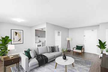 Hamilton apartment for rent - A living room with a grey couch, a coffee table, and a painting on the wall.