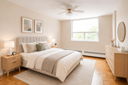 Hamilton apartment for rent - A bedroom with a large bed, a nightstand, and a window.