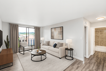 Dundas apartment for rent - A living room with a white couch, a coffee table, and a painting on the wall.