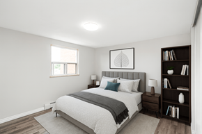 Dundas apartment for rent - A bedroom with a bed, nightstand, and bookshelf.