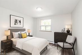 Hamilton apartment for rent - A bedroom with a bed, chair, and a picture on the wall.