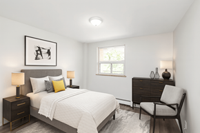 Hamilton apartment for rent - A bedroom with a bed, chair, and a picture on the wall.