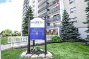Hamilton apartment for rent - A sign for Helvetia Apartments stands in front of a building.