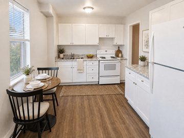 Hamilton apartment for rent - A kitchen with white cabinets and a wooden floor.