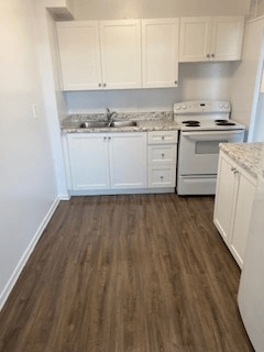 Hamilton apartment for rent - A kitchen with white cabinets and a white stove.