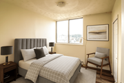 Hamilton apartment for rent - A bedroom with a bed, chair, and two lamps.