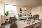 Hamilton apartment for rent - A living room with a grey sofa, a brown armchair, and a coffee table.
