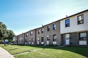 Kitchener apartment for rent - A row of houses with a blue sign in front.