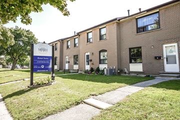 Kitchener apartment for rent - A McGehee senior living community with a blue sign in front of the building.