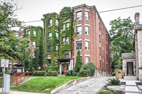 Hamilton apartment for rent - A red brick building with ivy growing on the side.