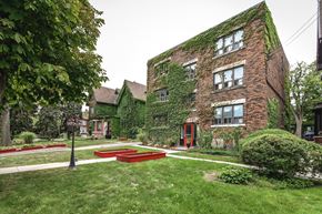 Hamilton apartment for rent - A red brick building with ivy growing on it.
