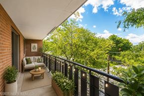 Hamilton apartment for rent - A balcony with a couch and a table with a candle on it.