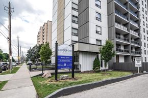 Hamilton apartment for rent - A sign for Wedgewood Apartments is displayed in front of a building.