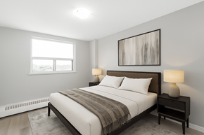 Hamilton apartment for rent - A bedroom with a large bed and a painting on the wall.