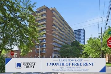 Hamilton apartment for rent - A large building with a sign in front that says "1 month of free rent".