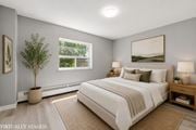 Hamilton apartment for rent - A bedroom with a large bed and a painting on the wall.