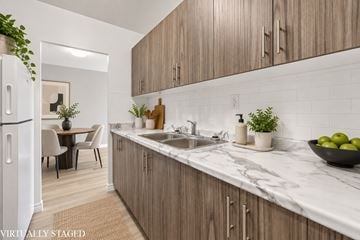 Hamilton apartment for rent - A kitchen with wooden cabinets and a marble countertop.