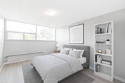 Hamilton apartment for rent - A bedroom with a large bed and a bookshelf.