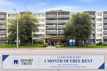Hamilton apartment for rent - A large apartment complex with a sign offering a free month of rent.