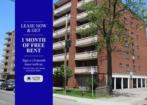 Hamilton apartment for rent - A tall building with a sign offering free rent for the first month.