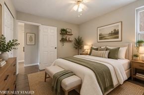 Hamilton apartment for rent - A bedroom with a bed, a bench, and a painting on the wall.