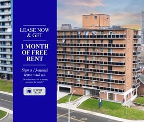 Hamilton apartment for rent - large building with a blue sign offering a free month of rent.