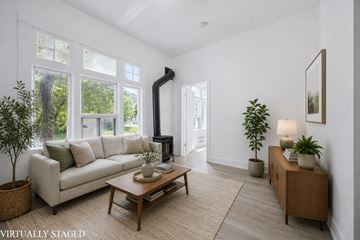 Kitchener apartment for rent - A living room with a white couch and a wooden coffee table.