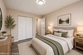 Stoney Creek apartment for rent - A bedroom with a bed, nightstands, and a painting on the wall.