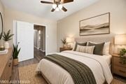 Hamilton apartment for rent - A bedroom with a bed, a ceiling fan, and a painting on the wall.