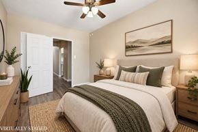 Hamilton apartment for rent - A bedroom with a bed, a ceiling fan, and a painting on the wall.