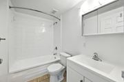 Hamilton apartment for rent - A white bathroom with a toilet, sink, and bathtub.