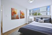 Hamilton apartment for rent - A bedroom with a large bed and two paintings on the wall.