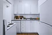 Hamilton apartment for rent - A kitchen with white cabinets and a stove top oven.