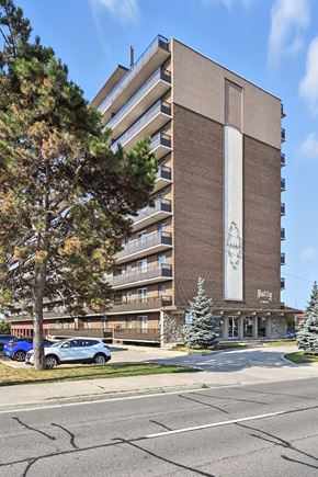 Hamilton apartment for rent - A large building with a tree in front of it.