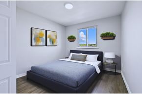 Hamilton apartment for rent - A bedroom with a bed, nightstand, and two framed pictures on the wall.