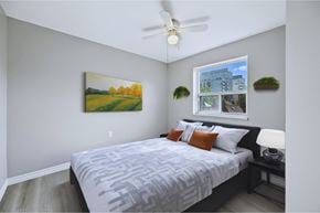 Hamilton apartment for rent - A bedroom with a large bed and a painting on the wall.