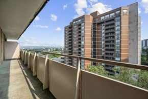 Hamilton apartment for rent - A long balcony with a building in the background.