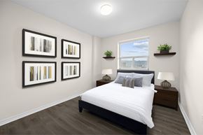 Hamilton apartment for rent - A bedroom with a large bed and a window with a view of the city.