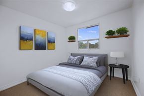 Hamilton apartment for rent - A bedroom with a bed, nightstand, and two paintings on the wall.