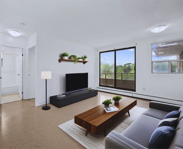 Hamilton apartment for rent - A modern living room with a grey couch and a wooden coffee table.